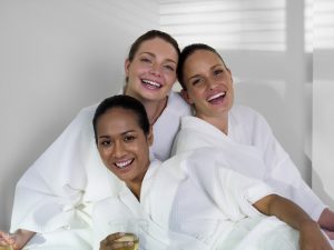 Women wearing spa robes. Friends enjoying a pamper party together.