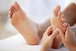 Close-up of hands of massage therapist giving a foot massage
