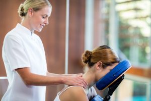 Woman relaxing with chair massage treatments at work